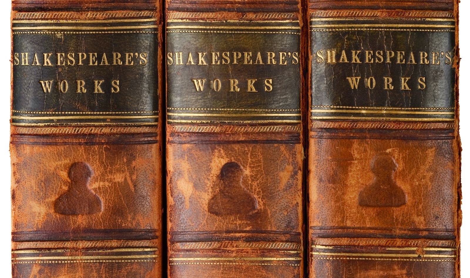Three old leather-bound books of Shakespeare's works