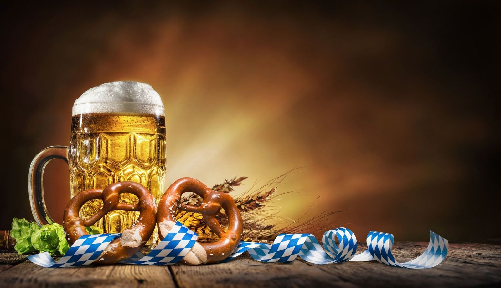 Brown backdrop with skein of beer and pretzel in the foreground
