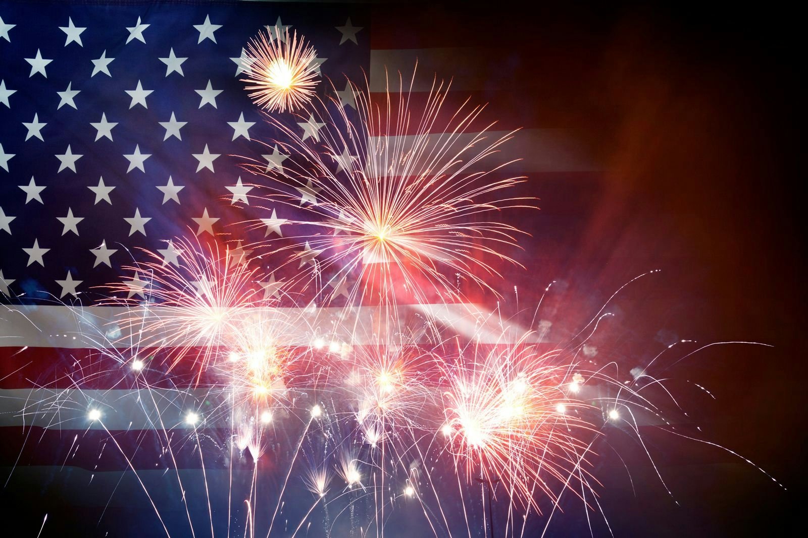 Fireworks against an American flag backdrop