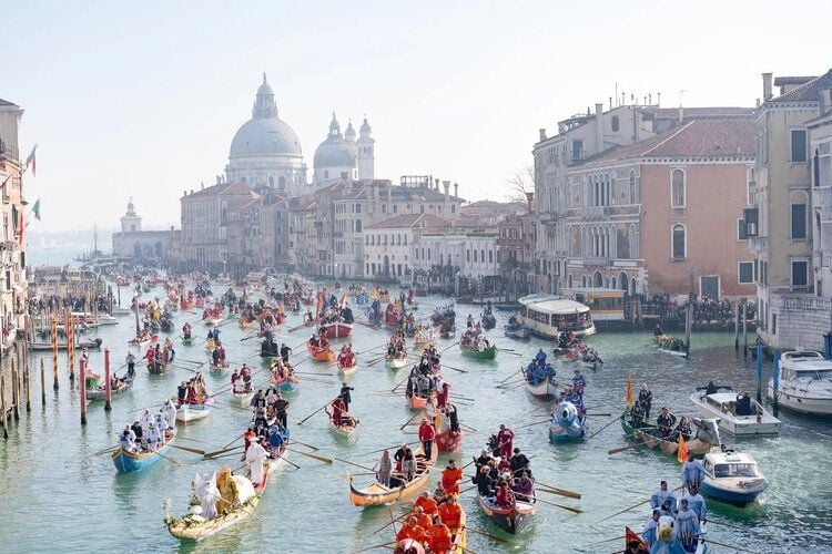 A regatta makes its way along the Grand Canal in Venice, one of the best things to do in Italy