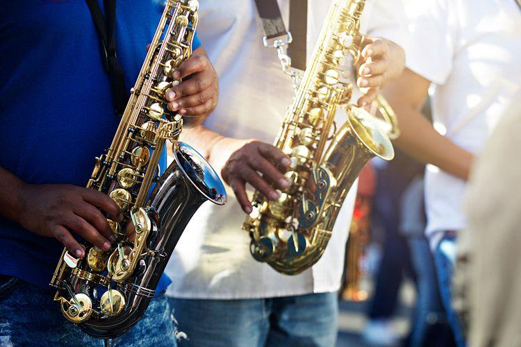 Two men playing saxophones