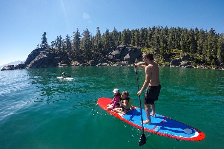 Lake Tahoe cabin rentals for 4th July, paddleboarder