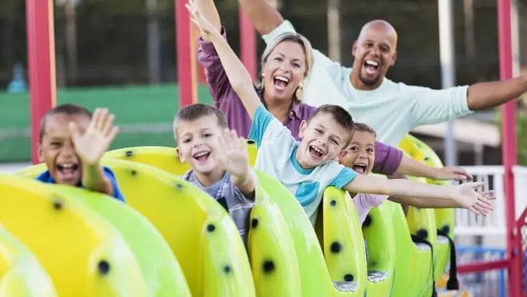 A family enjoying a roller coaster