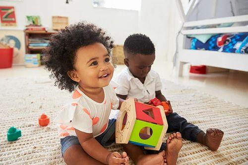 Two young children playing with toys