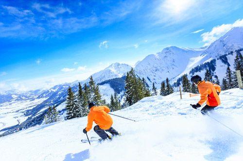 Two people in orange coast skiing in Lake Tahoe