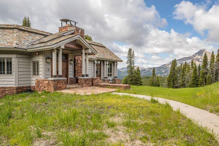Big Sky cabin rentals Big Sky 7 wooden cabin with mountains behind