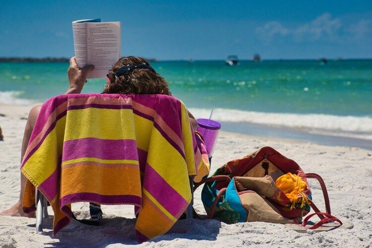 Bes time to visit Jamaica, solo traveler reading a book on beach, Top Villas
