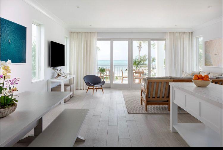 Islamorada Premium Villa 1 - Ocean Views inside shot of living room with couch, chair and balcony with sea view