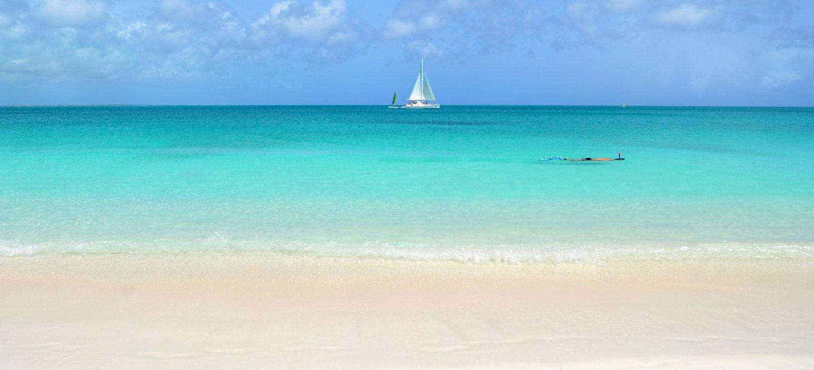 Grace Bay view with sailboat and snorkeler