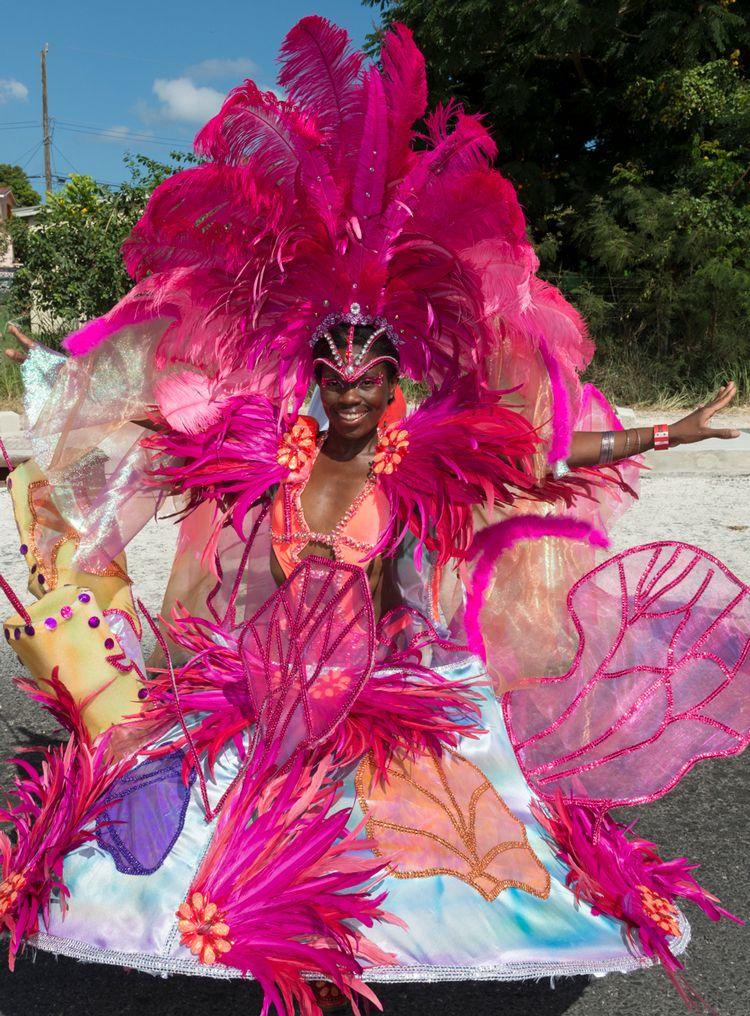A lady wearing a flamboyant pink carnival costume in Barbados