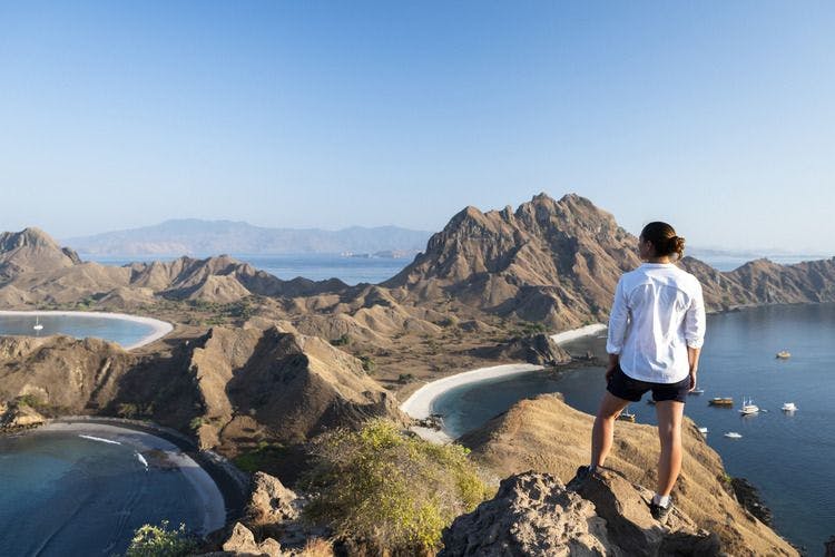 A female hiker takes in the view of Komodo National Park