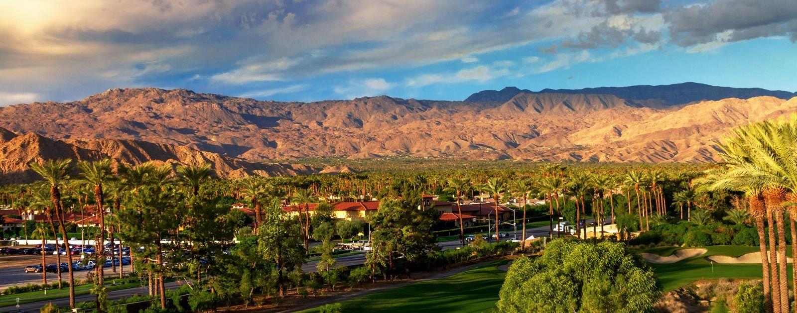 Indio landscape with palm trees, sand and mountains