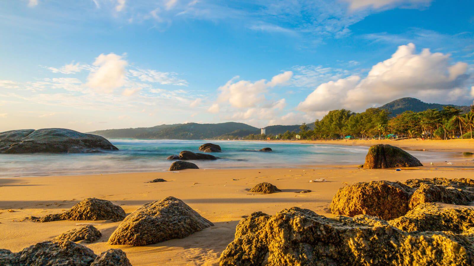 Kamala beach with sea rocks on the sand