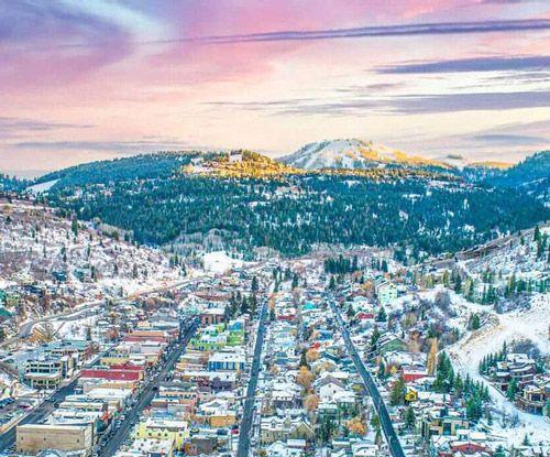 Winter in Park City, with snow-dusted buildings and mountains in the background