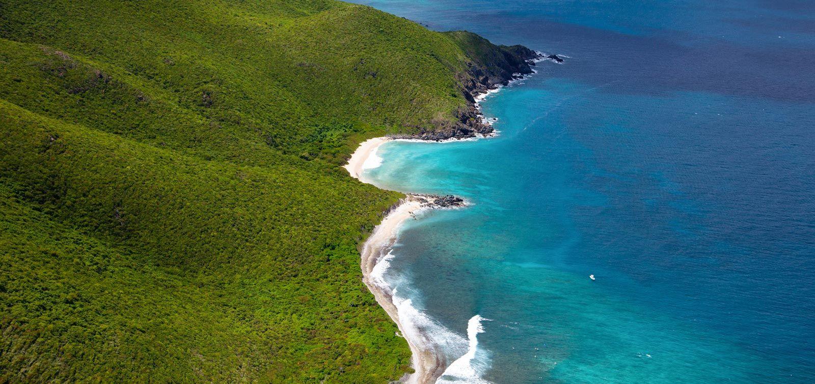 Verdant coastline with white sand beaches and bright blue sea