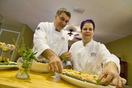 Two chefs preparing a dish
