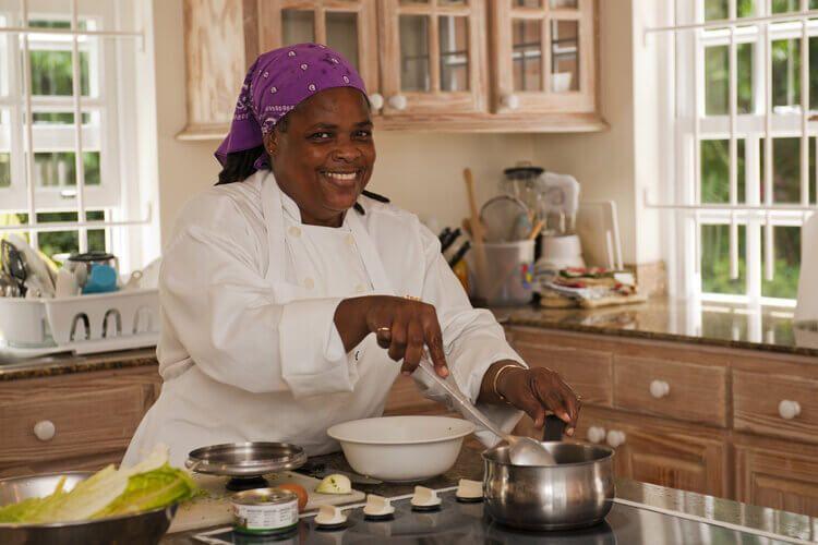 A Caribbean villa private chef prepares a delicious meal in a vacation home.