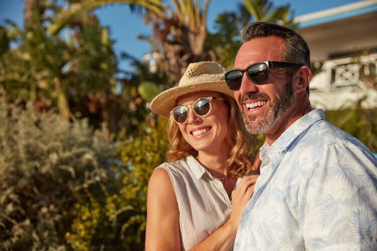 Couple enjoying their view from their romantic beachfront vacation rental