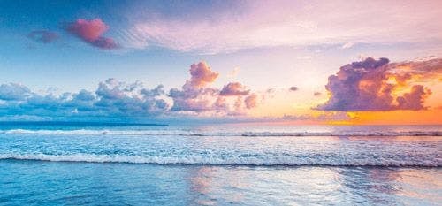 Pastel-colored sky at sunrise over the sea