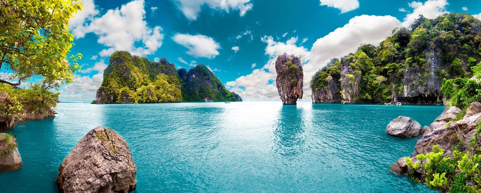 Large limestone rocks rising from the sea in a bay in Thailand