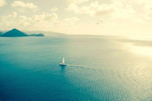 A small sailboat on a calm sea in the Caribbean