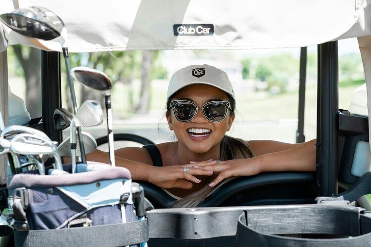 Golf in Florida, smiling female player with golfing equipment