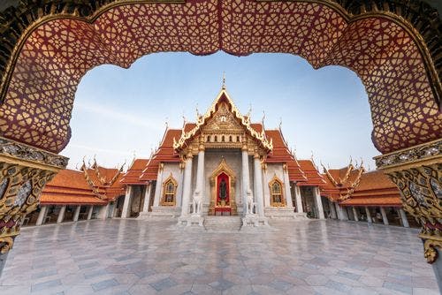 View of Grand Palace through ornate archway