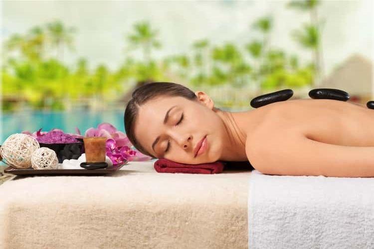 Lady unwinds during a hot stone massage.