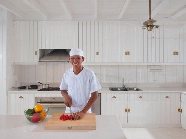 A chef prepares vegetables in a private kitchen