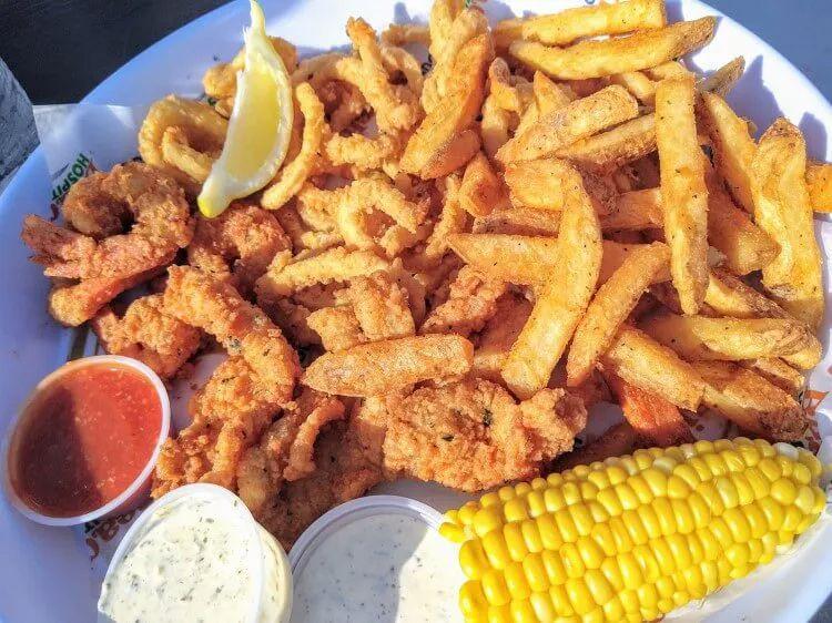 A plate of fried food with chips and corn