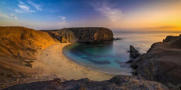 Lanzarote coast landscape with an arc of golden sand and se a cliffs