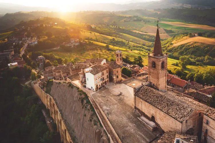 Le Marche hilltop town with church and stone buildings