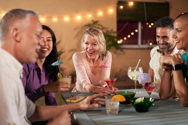 A group of people sitting around a restaurant table enjoying drinks