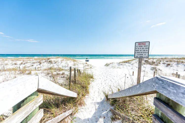 Steps leading onto the white sand of Miramar Beach