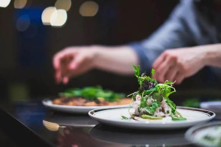 A chef prepares dishes on a counter