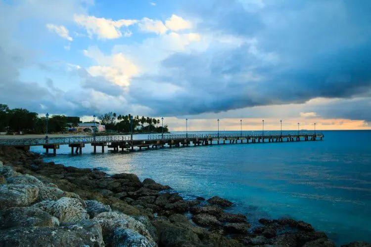 Pier into the sea by a rocky beach