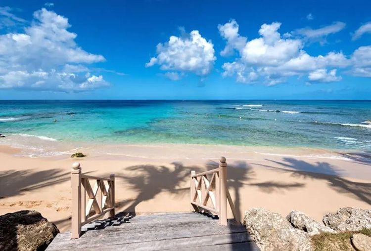 Wooden steps onto a white sand beach