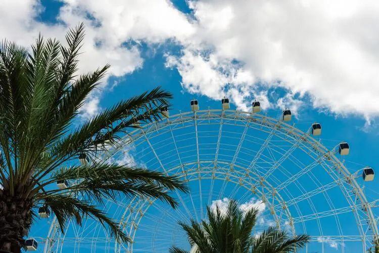 A big wheel against a blue cloudy sky