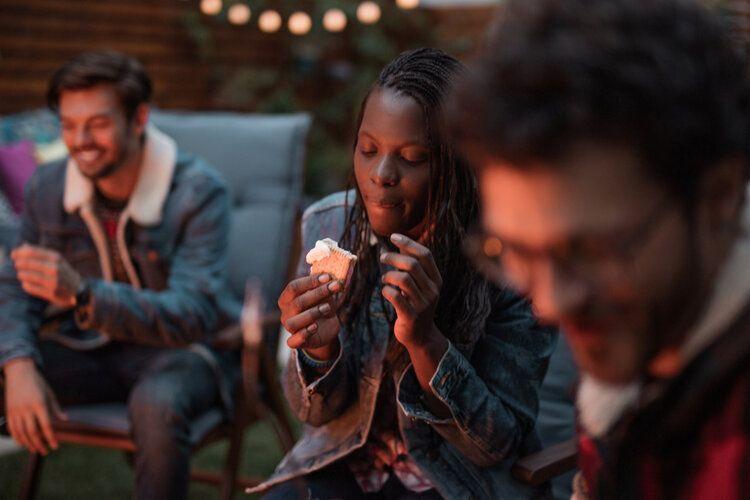 A lady tucks into a s'mores snack