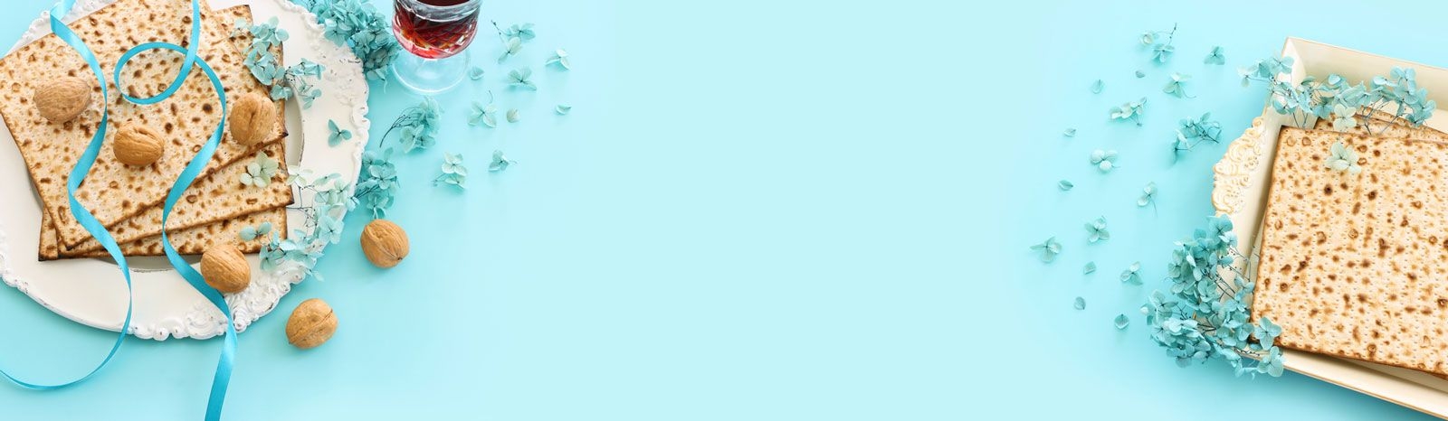 Passover background with bread and nuts against a pale blue backdrop