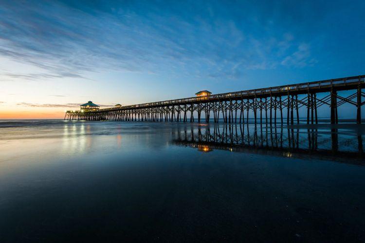 Long wooden pier into the sea on a Sea Islands beach