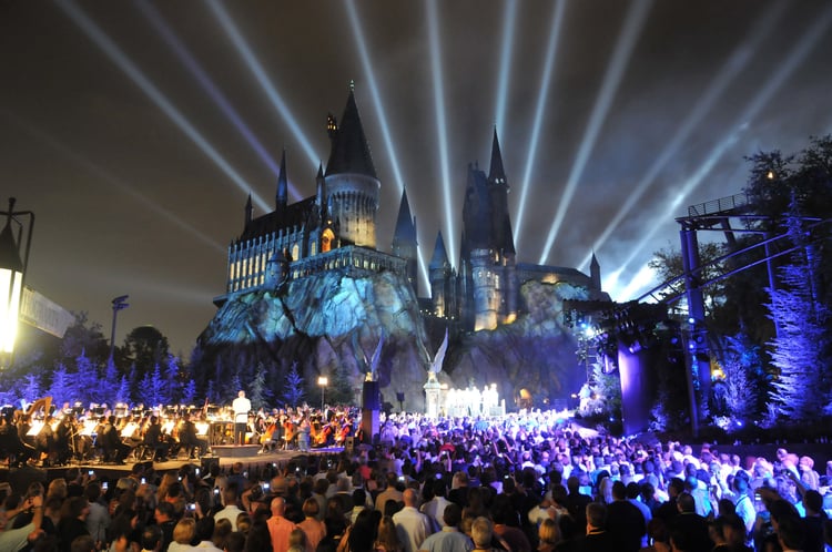 An orchestra performing in front of Hogwarts Castle at the Wizarding World of Harry Potter. Universal Studios vs Disney World.