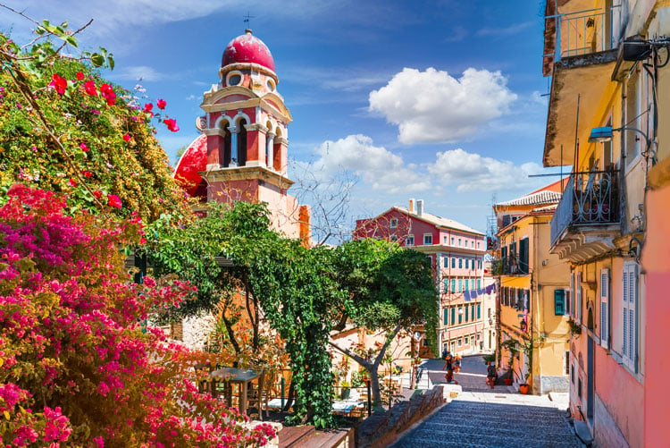 The best places to visit in September - city center with church and colorful flowers in Corfu