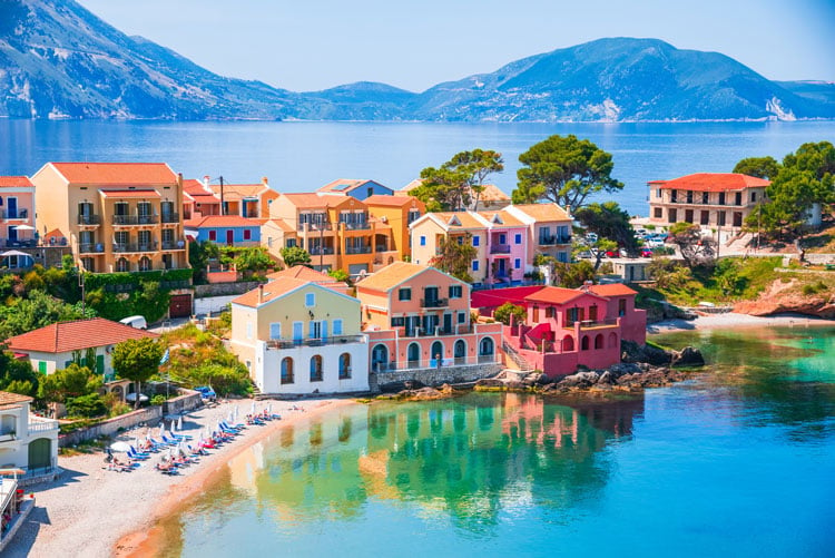 The best places to visit in September - colorful buildings by the sea in Kefalonia