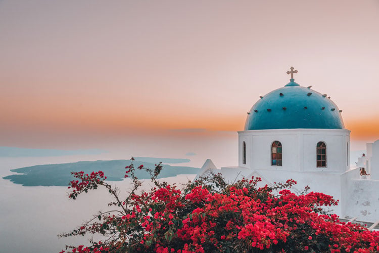 The best places to visit in September - blue domed church in Santorini