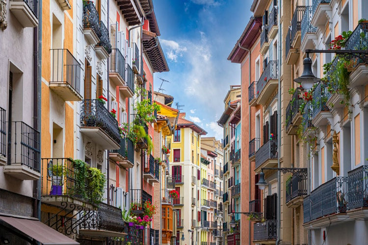 The best places to visit in September - narrow street with tall colorful buildings